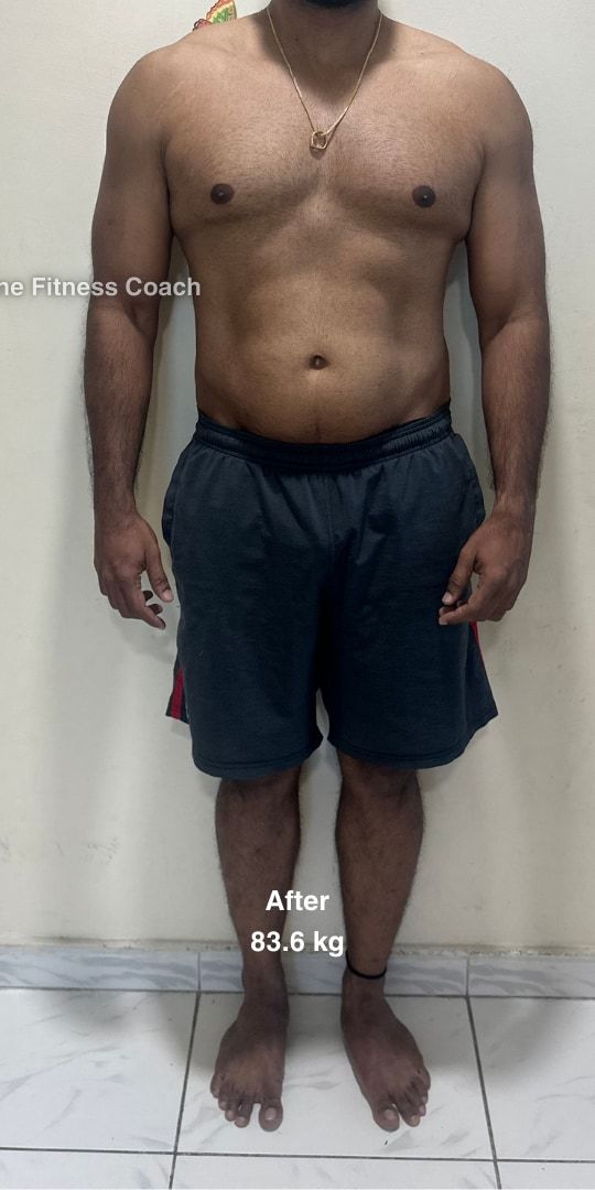 Madhan after, framed from the neck down: same pose, leaner through the waist, 83.6 kg.