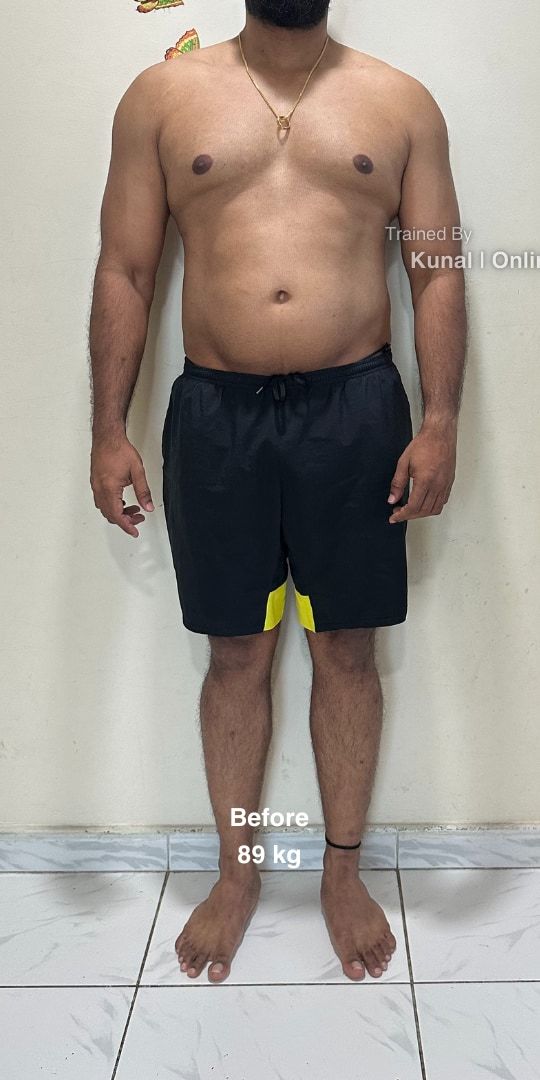 Madhan before, framed from the neck down: standing in black shorts against a white wall, 89 kg.