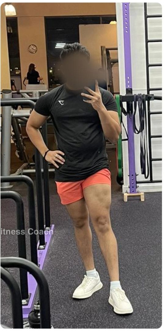 Sid after: full length in a gym, in a black T-shirt and orange shorts, visibly more muscular, face blurred.