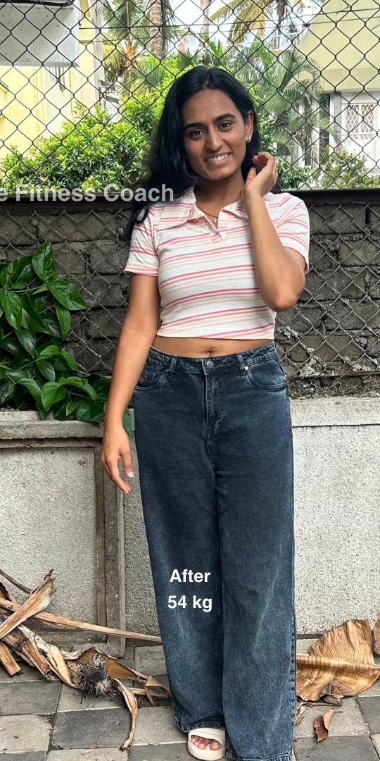 Uma after: outdoors in a striped crop top and dark jeans, smiling, visibly leaner, 54 kg.